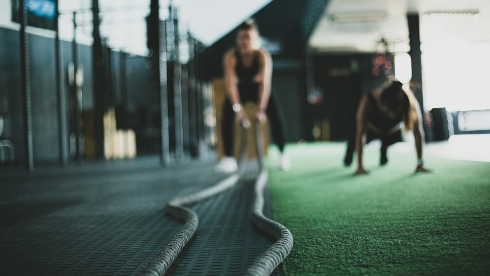 Athletes training with battle ropes